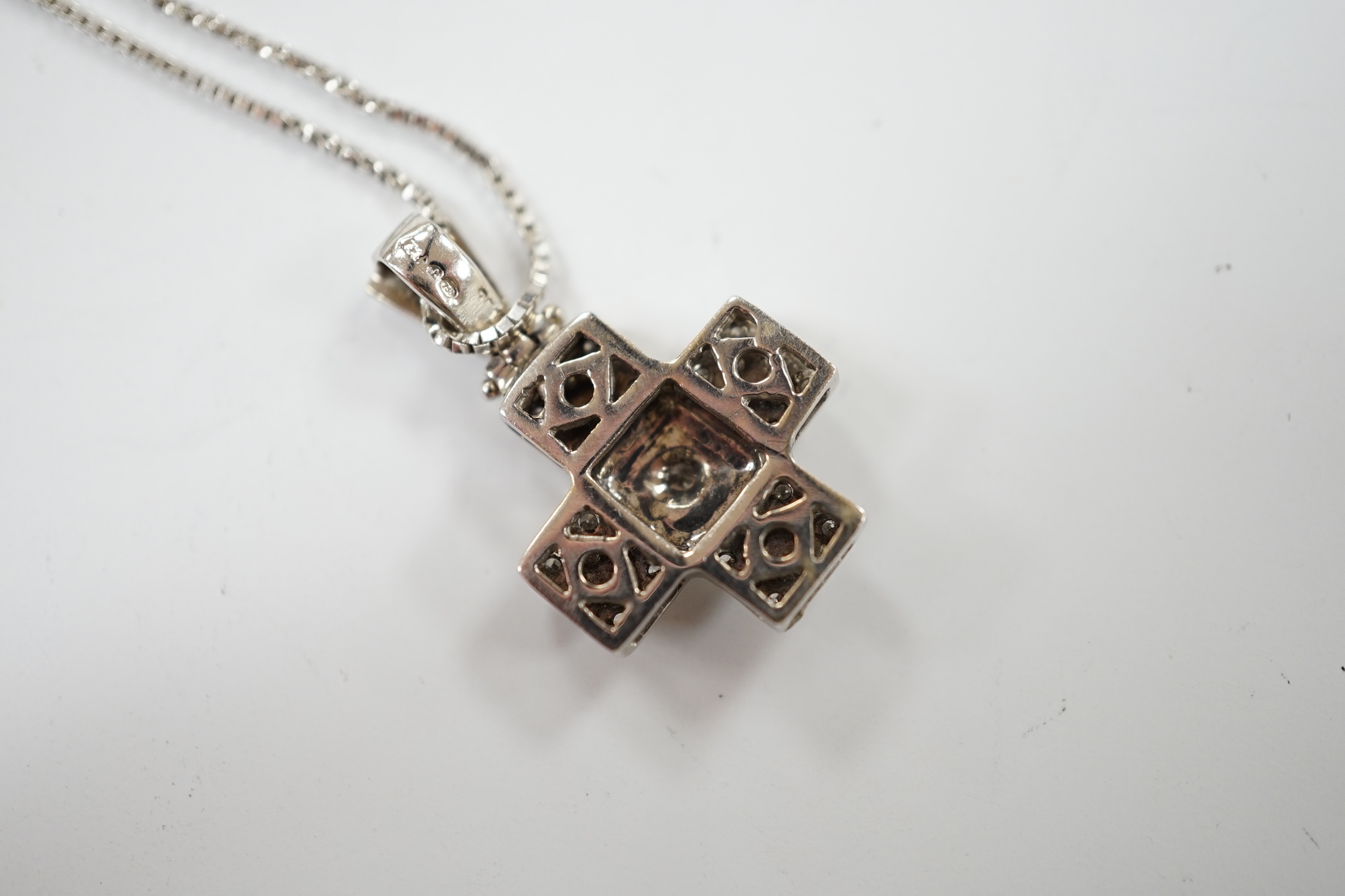 A modern 18ct white gold and diamond cluster set cross pendant, overall 25mm, on an 18ct white gold fine link chain, 40cm, gross weight 6.1 grams. Condition - good